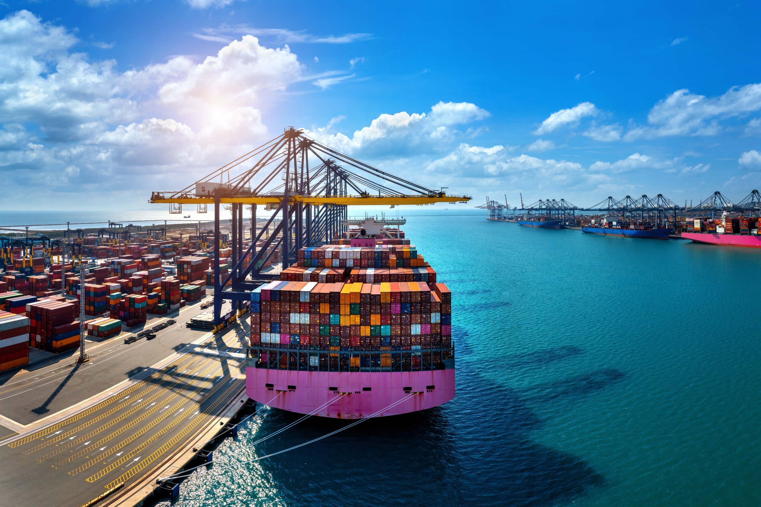 Illustration of a freighter ship with containers docked in the harbor